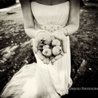 Creative Bridal Session black and white photograph with bride holding 5 apples in a mother earth style pose