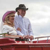 Creative Bridal Session with close up moment of Bride and Groom in a Clydesdale horse drawn red wagon